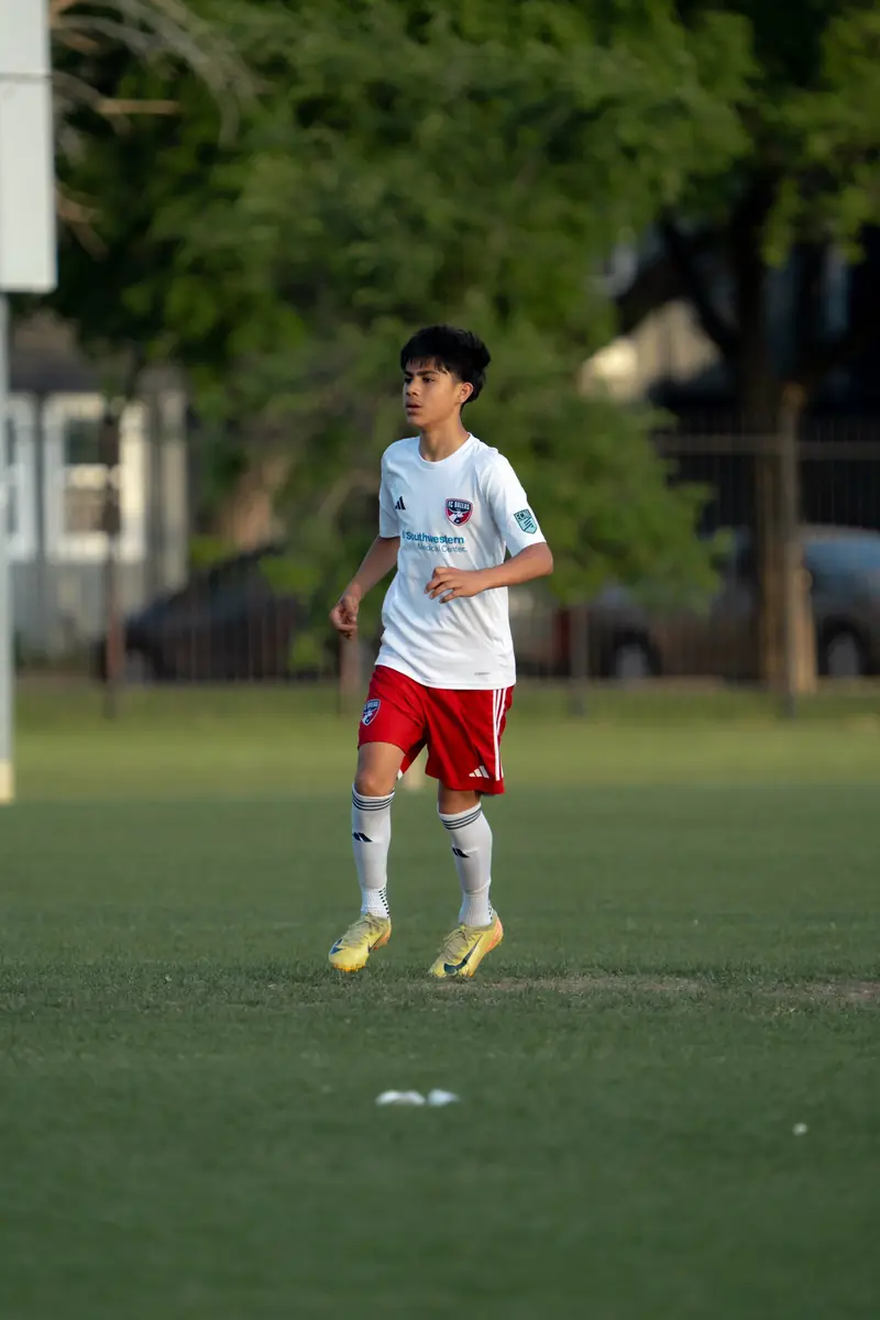 Youth soccer player in golden hour light during a match in Dallas
